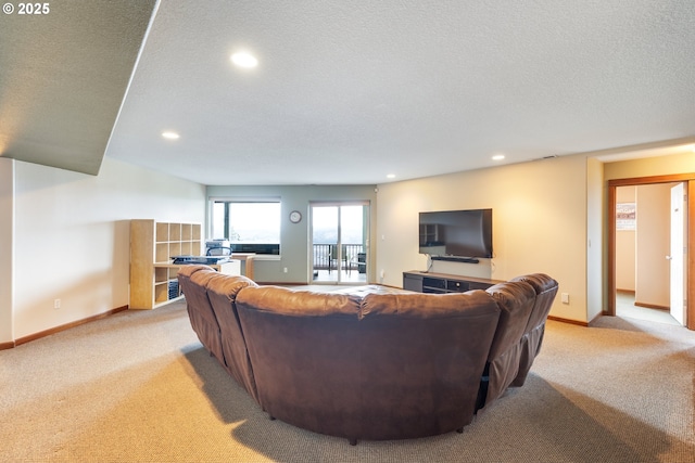 living area featuring a textured ceiling, baseboards, and light colored carpet