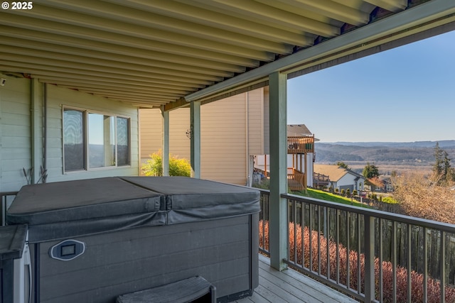 balcony featuring a deck with mountain view and a hot tub