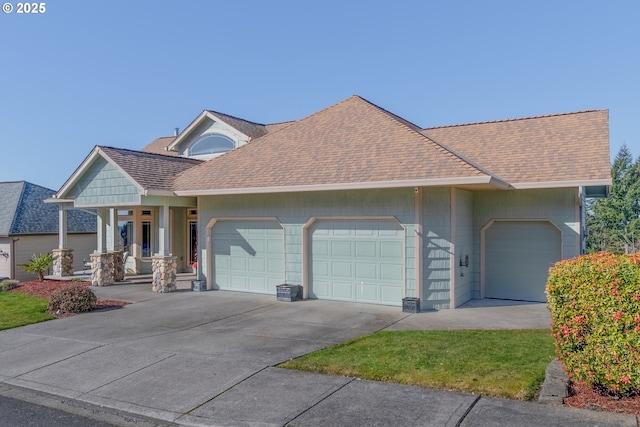 view of front of house with a garage, roof with shingles, and driveway