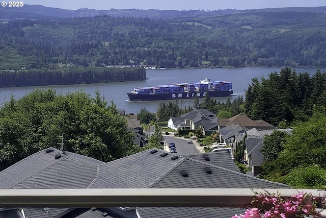 birds eye view of property with a water view and a view of trees