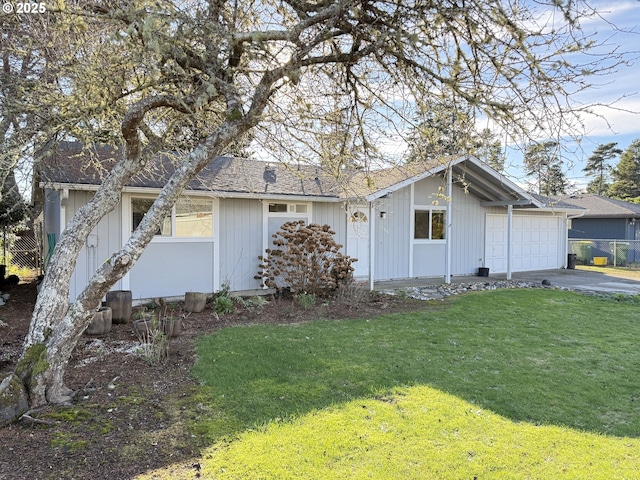 view of front of house with a front yard and a garage