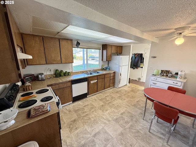 kitchen featuring white appliances, a textured ceiling, ceiling fan, ventilation hood, and sink