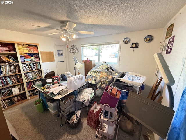 carpeted home office featuring a textured ceiling and ceiling fan