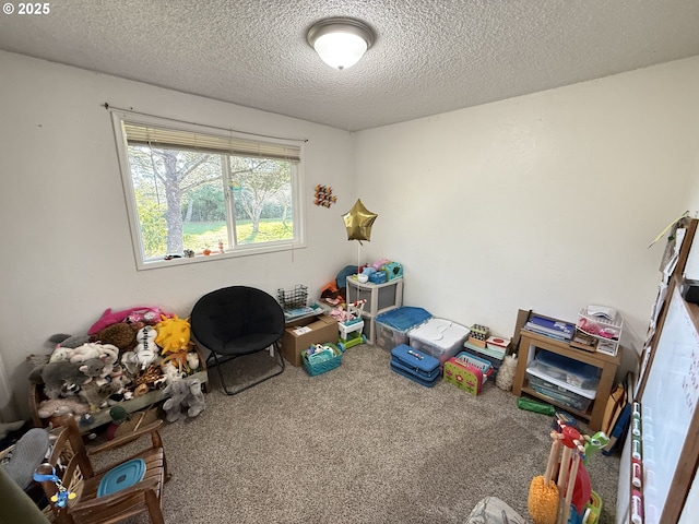 rec room featuring a textured ceiling and carpet