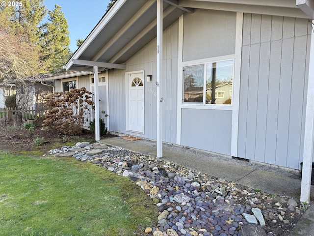 entrance to property with a lawn