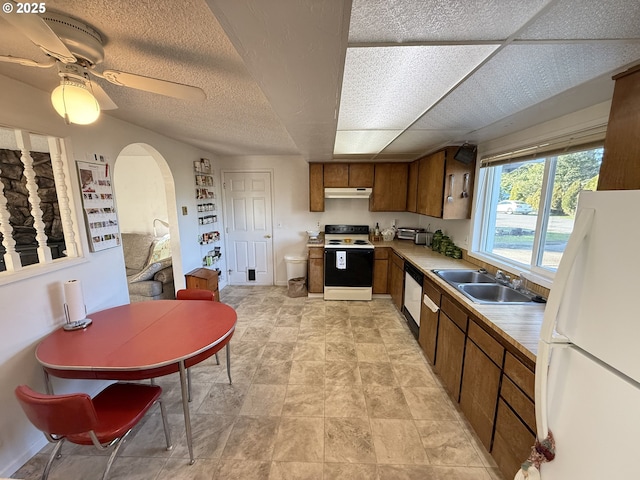 kitchen with dishwasher, electric range, white refrigerator, ceiling fan, and sink