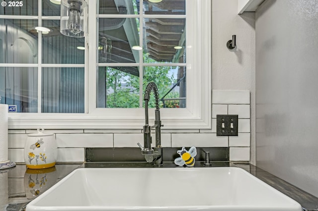kitchen view of a sink and a textured wall