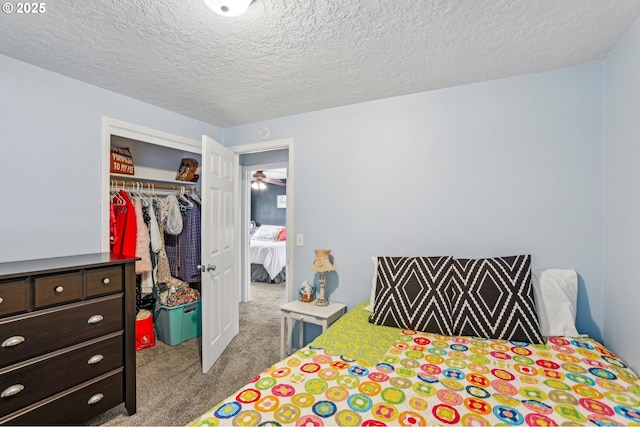 bedroom with carpet, a closet, and a textured ceiling