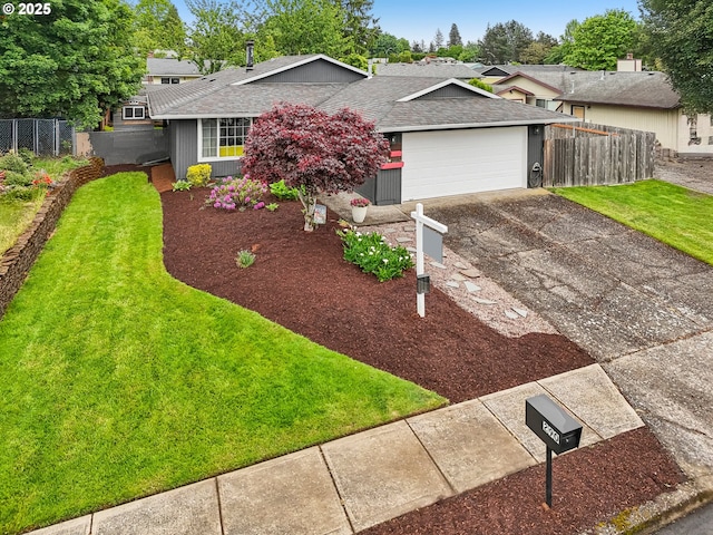 view of front of property featuring asphalt driveway, a shingled roof, and a garage