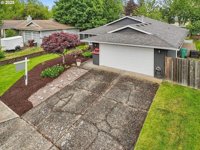 ranch-style home featuring roof with shingles and driveway