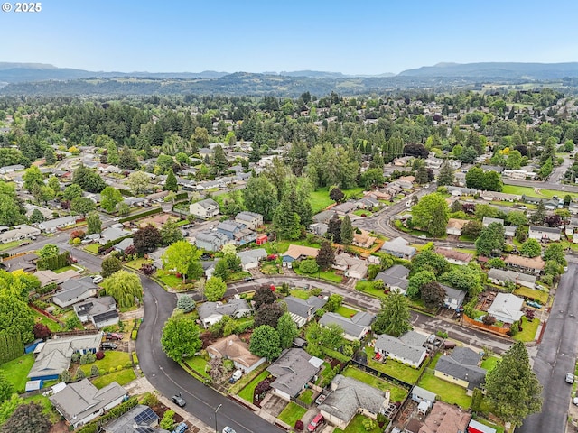 aerial view of property's location with nearby suburban area and a mountain backdrop