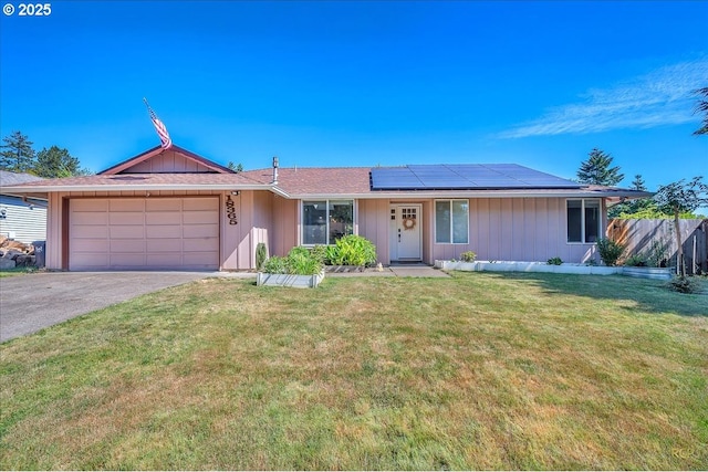18365 SW Springfield St, Beaverton, OR 97078 - ranch-style house featuring roof mounted solar panels, asphalt driveway, an attached garage, and board and batten siding