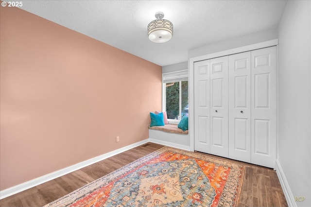 18365 SW Springfield St, Beaverton, OR 97078 - bedroom featuring wood finished floors, baseboards, a closet, and a textured ceiling