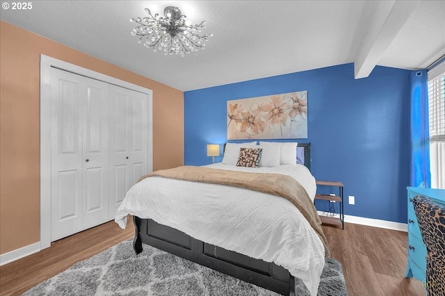 18365 SW Springfield St, Beaverton, OR 97078 - bedroom featuring a chandelier, wood finished floors, baseboards, a closet, and beamed ceiling