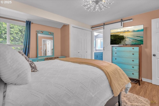 18365 SW Springfield St, Beaverton, OR 97078 - bedroom featuring wood finished floors, a chandelier, multiple windows, and a closet
