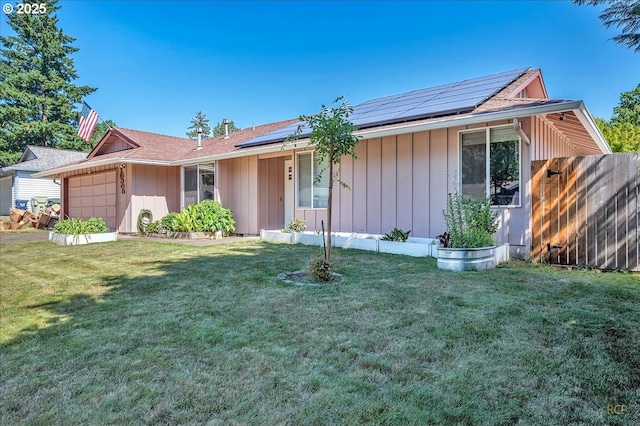 18365 SW Springfield St, Beaverton, OR 97078 - ranch-style house with an attached garage, board and batten siding, and roof mounted solar panels