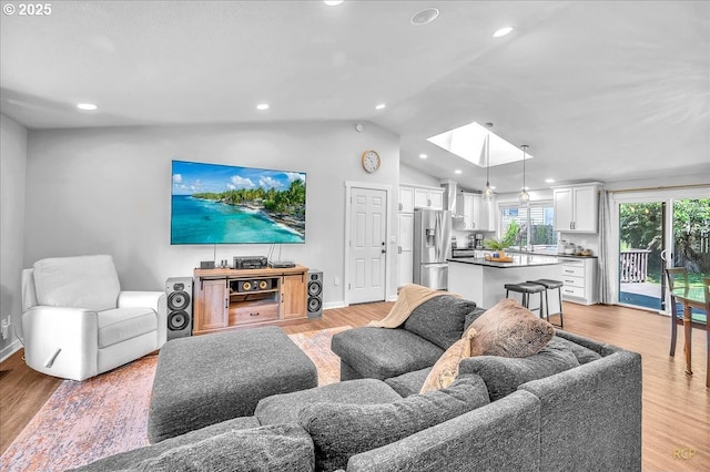 18365 SW Springfield St, Beaverton, OR 97078 - living area featuring a skylight, light wood-style floors, vaulted ceiling, recessed lighting, and baseboards