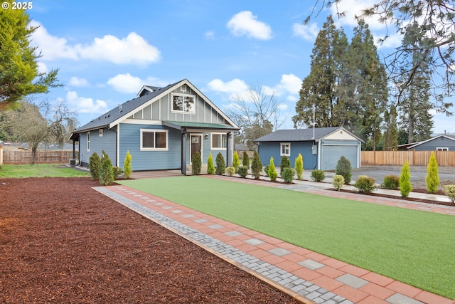 view of front of property with a garage and an outbuilding