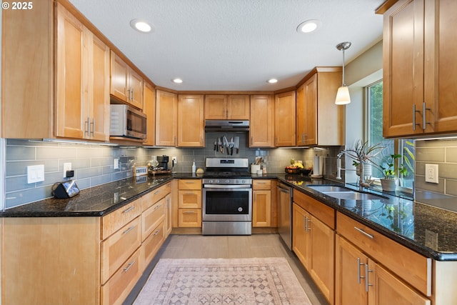 13527 SW Ashbury Ln, Portland, OR 97223 - kitchen with stainless steel appliances, under cabinet range hood, tasteful backsplash, recessed lighting, and dark stone countertops