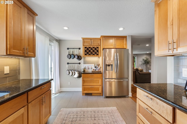 13527 SW Ashbury Ln, Portland, OR 97223 - kitchen with stainless steel refrigerator with ice dispenser, backsplash, recessed lighting, and dark stone countertops