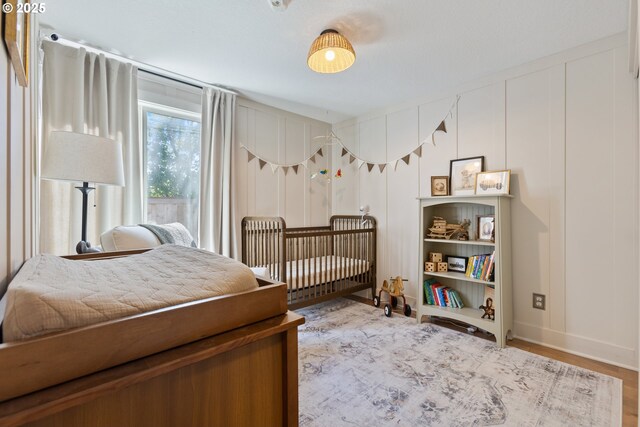 13527 SW Ashbury Ln, Portland, OR 97223 - bedroom featuring wood finished floors and a decorative wall