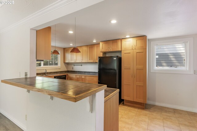 2702 Fairmount Ave, Vancouver, WA 98661 - kitchen featuring freestanding refrigerator, a peninsula, a breakfast bar, tile countertops, and baseboards