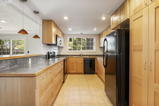 2702 Fairmount Ave, Vancouver, WA 98661 - kitchen with black appliances, light brown cabinetry, recessed lighting, decorative light fixtures, and tile counters