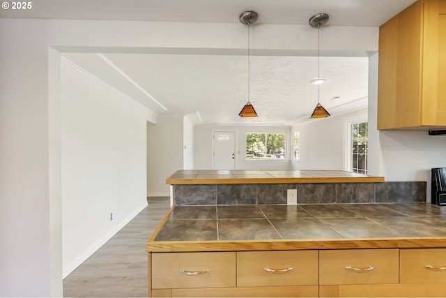 2702 Fairmount Ave, Vancouver, WA 98661 - kitchen with tile counters, wood finished floors, pendant lighting, ornamental molding, and baseboards