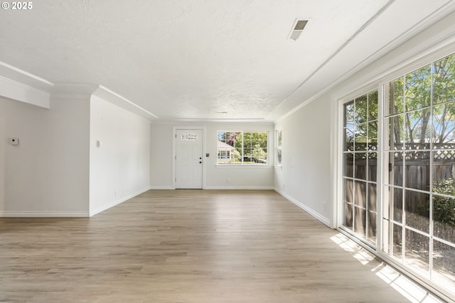 2702 Fairmount Ave, Vancouver, WA 98661 - empty room featuring light wood finished floors, baseboards, ornamental molding, and a textured ceiling