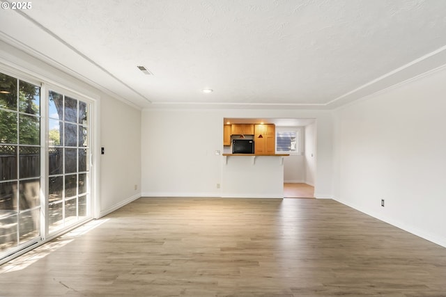 2702 Fairmount Ave, Vancouver, WA 98661 - unfurnished living room featuring wood finished floors, baseboards, and crown molding