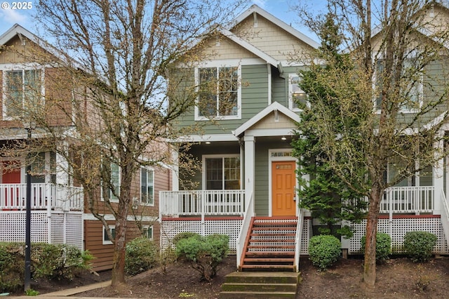 view of front of property with stairs and covered porch