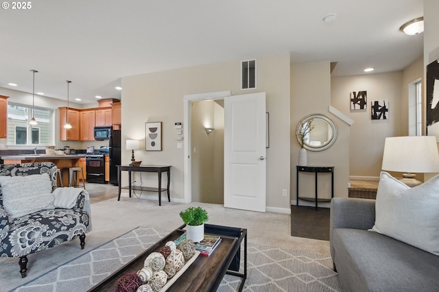 living room featuring recessed lighting, visible vents, light carpet, and baseboards