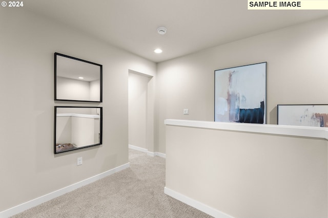 corridor featuring baseboards, recessed lighting, and carpet