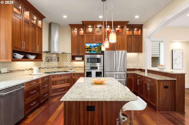 4018 NW Riggs Dr, Portland, OR 97229 - kitchen with dark wood-type flooring, a peninsula, wall chimney range hood, stainless steel appliances, and backsplash