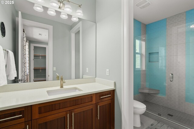 4018 NW Riggs Dr, Portland, OR 97229 - full bath featuring vanity, toilet, a shower stall, a walk in closet, and visible vents