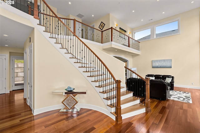 4018 NW Riggs Dr, Portland, OR 97229 - stairway featuring a towering ceiling, baseboards, recessed lighting, visible vents, and wood finished floors