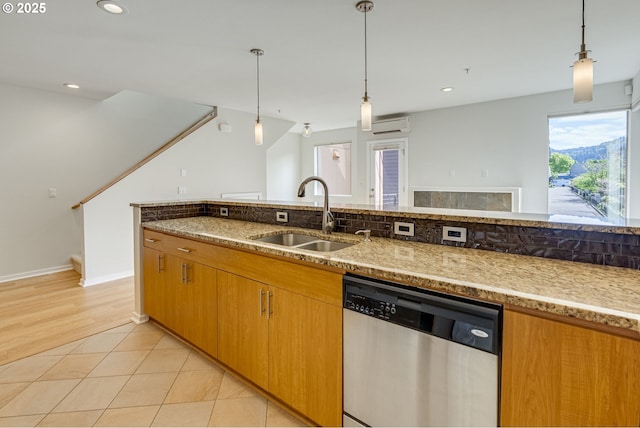 8522 N Central St Unit 17-1, Portland, OR 97203 - kitchen featuring stainless steel dishwasher, a sink, an AC wall unit, light stone countertops, and decorative light fixtures