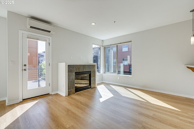 8522 N Central St Unit 17-1, Portland, OR 97203 - unfurnished living room with an AC wall unit, light wood-style floors, baseboards, and recessed lighting
