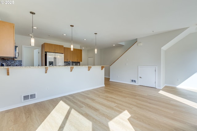 8522 N Central St Unit 17-1, Portland, OR 97203 - unfurnished living room with light wood-style flooring, recessed lighting, baseboards, stairway, and a sink