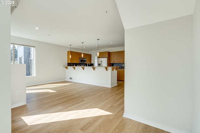8522 N Central St Unit 17-1, Portland, OR 97203 - unfurnished living room featuring recessed lighting, light wood finished floors, and baseboards
