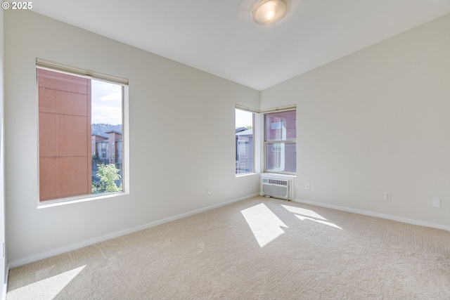 8522 N Central St Unit 17-1, Portland, OR 97203 - carpeted empty room with a wall unit AC, baseboards, and vaulted ceiling