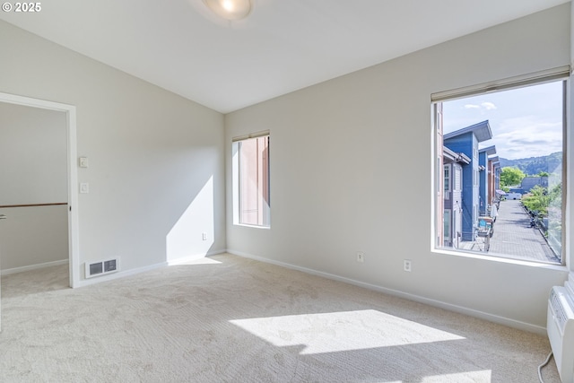 8522 N Central St Unit 17-1, Portland, OR 97203 - unfurnished room featuring carpet floors, vaulted ceiling, baseboards, and an AC wall unit