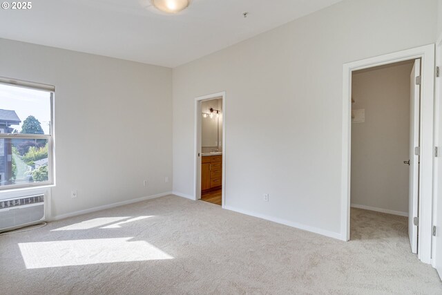 8522 N Central St Unit 17-1, Portland, OR 97203 - unfurnished bedroom with light colored carpet, a spacious closet, a wall mounted air conditioner, connected bathroom, and baseboards
