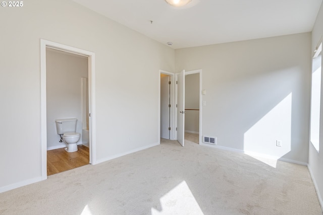 8522 N Central St Unit 17-1, Portland, OR 97203 - unfurnished bedroom with carpet, a walk in closet, ensuite bath, and baseboards