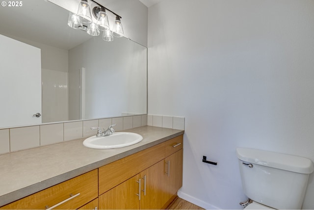 8522 N Central St Unit 17-1, Portland, OR 97203 - bathroom featuring toilet, vanity, and backsplash