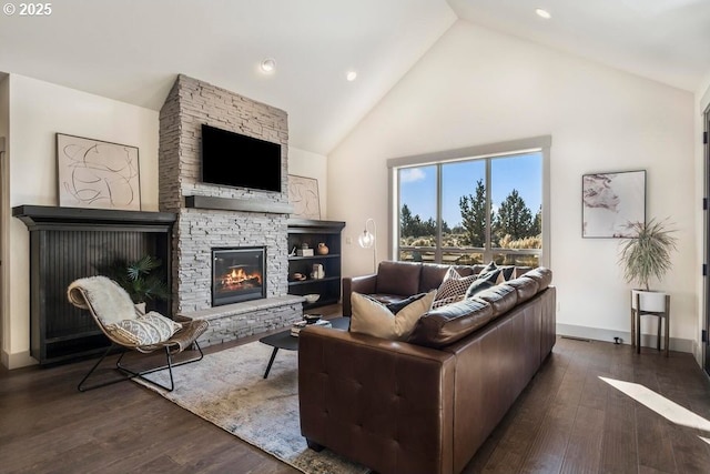 living room with a fireplace, high vaulted ceiling, and dark hardwood / wood-style floors