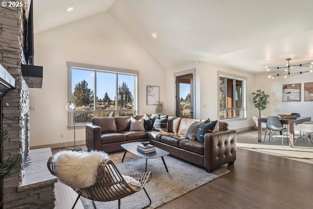 living room featuring hardwood / wood-style flooring, a fireplace, and high vaulted ceiling