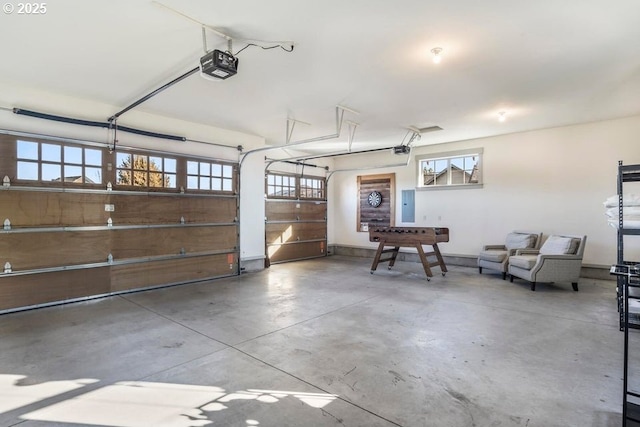 garage with a garage door opener and electric panel