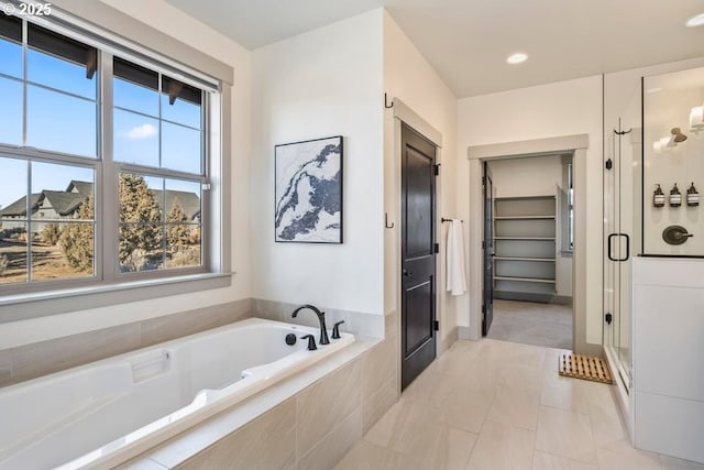 bathroom featuring separate shower and tub