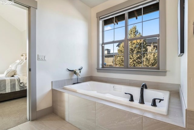 bathroom featuring tile patterned flooring and a relaxing tiled tub